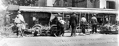Men and boys with bicycles view trolleys overturned during the Denver Tramway Company labor strike in August, 1920. The trolleys are in front of the Immaculate Conception Cathedral on Colfax Street in Denver, Colorado.  
Source: James E. Kunkle, Denver Tramway Historian, P.O. Box 2984, Denver, Colorado 80201.  
Call Number: X-18352.  URL: http://gowest.coalliance.org/cgi-bin/imager?10018352+X-18352

Hyperlink to Denver Public Library.