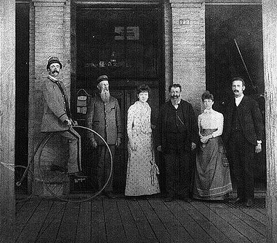 Employees of the Salem Post Office at the Women's Christian Temperance Union Building. In 1880 the Post Office was located at Commercial Street and the corner of Ferry Street.  From left: Ben Taylor on a penny farthing or ordinary as it was sometimes called, George Hatch, Sadie Palmer, Rich Dearborn, Ella Dearborn and Captain L. Scott.

TITLE: 1304.  PHOTOGRAPHER: unknown.  COLLECTOR: Mr. Ben Maxwell.  RECORD: 1304.  OBJECT: b/w photo; negative.  DATE: 1880.  LOCATION: SPO.1.2.  IMAGE FILECODE: 50EC7C2B.JPG. Salem Public Library.
