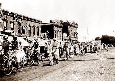 Soldiers Day on Main Street in Greeley, Colorado welcoming home Company D from Manila, bicycle section of G.H.S. on 8th St between 8th & 9th Aves.  Sept. 19, 1899.  SUMMARY: Women ride bicycles on 8th (Eighth) Street with United States flags on the handlebars in Greeley, Colorado. Two-story, brick commercial buildings in the background are draped with bunting; trees are further down the street.

REPRODUCTION NUMBER: X-9051.  REPOSITORY: Western History/Genealogy Department, Denver Public Library, 10 W. 14th Avenue Parkway, Denver, Colorado 80204.  DIGITAL ID: 
codhawp 10009051 http://gowest.coalliance.org/cgi-bin/imager?10009051.